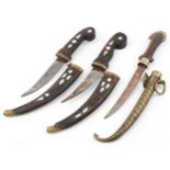 Three Indian daggers including two with hardwood handles and sheaths having mother of pearl inlay,