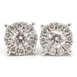 Pair of 14ct white gold diamond stud earrings, the central diamond approximately 4.45mm in diameter,