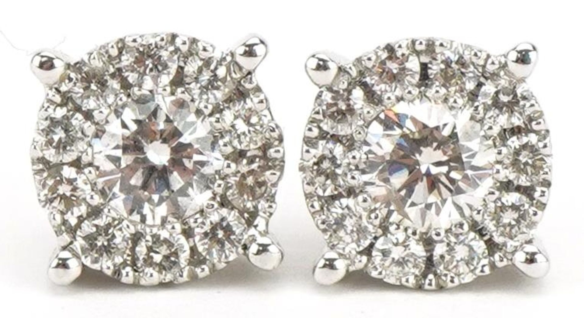 Pair of 14ct white gold diamond stud earrings, the central diamond approximately 4.45mm in diameter,