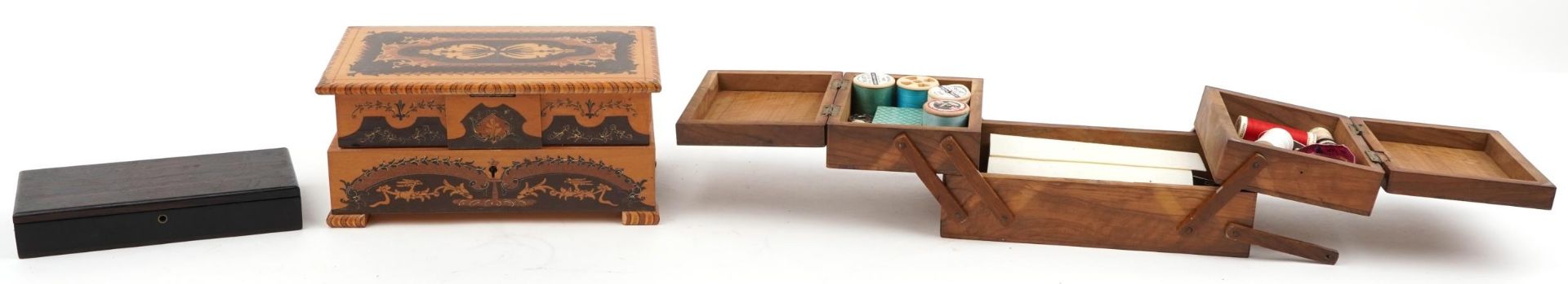 Wooden Sorento ware musical jewellery box, olive wood cantilever sewing box and an ebony box, the