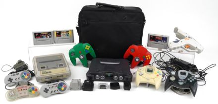 Two Nintendo 64 games consoles with controllers and games comprising Nintendo 64 and Super