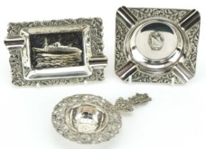 Two shipping interest silver ashtrays and a silver sifting spoon with cavalier terminal, the largest