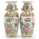 Pair of Chinese Canton porcelain vases decorated in relief with dragons, each hand painted in the