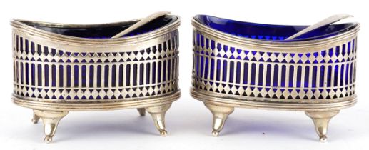 Stokes & Ireland Ltd, pair of Edwardian pierced silver table salts with blue glass liners and two