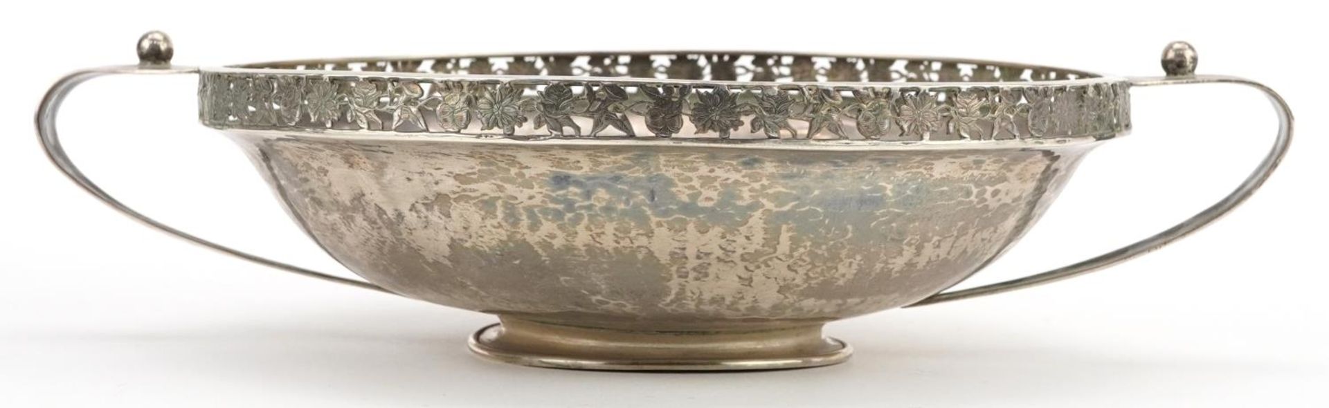 A E Jones, Arts & Crafts planished footed bowl with twin handles and pierced floral border, - Image 2 of 4