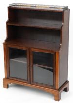 Regency rosewood waterfall bookcase with brass gallery and glazed cupboard base enclosing an