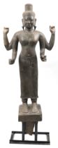 Large Cambodian Khmer Empire stone deity finely carved with robe, on later stand, the carving