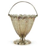 Henry Wilkinson & Co, Victorian silver pedestal basket pierced with foliage, with swing handle and