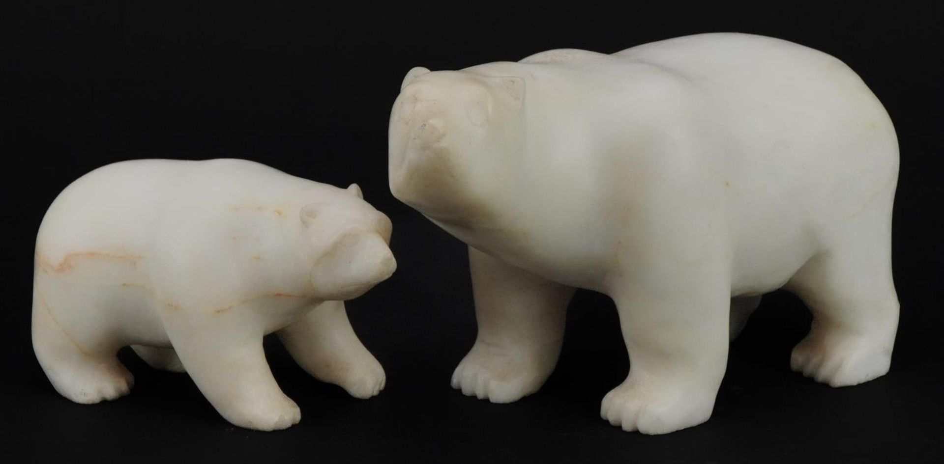 Two Art Deco style carved alabaster polar bears, the largest 19.5cm in length : For further