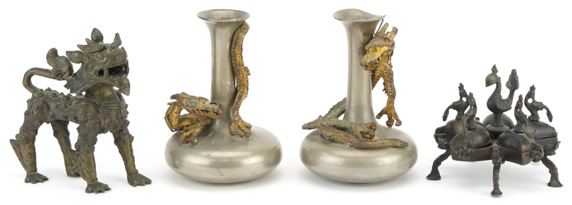Indian and Asian metalware including a pair of pewter vases surmounted with dragons, the largest