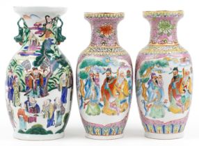 Three Chinese porcelain vases including a pair, each hand painted in the famille rose palette with
