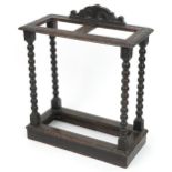 Antique oak stick stand with bobbin turned supports carved with flower heads, 75cm H x 63cm W x 30cm