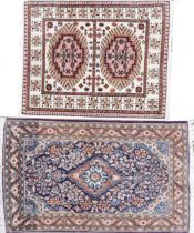 Two rectangular rugs including a blue ground Persian example, the largest 110cm x 69cm : For further