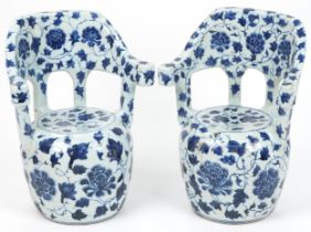 Pair of Chinese blue and white porcelain garden seats hand painted with flowers, each 64cm high :