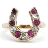 Unmarked gold diamond and ruby horseshoe ring, tests as 15ct gold, the largest diamond approximately