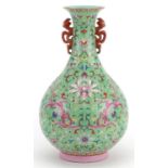 Chinese porcelain green ground vase with iron red handles hand painted in the famille rose palette