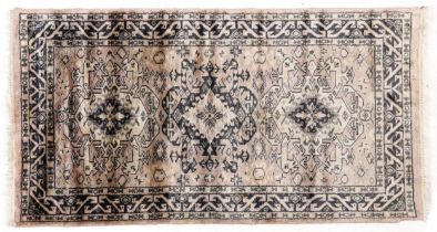 Rectangular pink and blue ground rug having an all over geometric design, 130cm x 75cm : For further