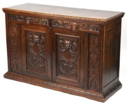 Victorian oak sideboard fitted with two frieze drawers above cupboard base carved with masks amongst