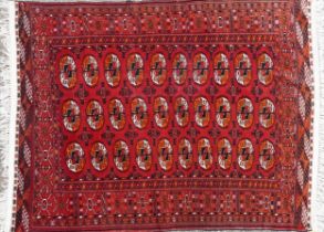 Rectangular Persian red ground rug having an allover repeat design, 170cm x 120cm : For further