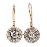 Pair of unmarked gold diamond cluster drop earrings, each centre diamond approximately 0.30 carat,