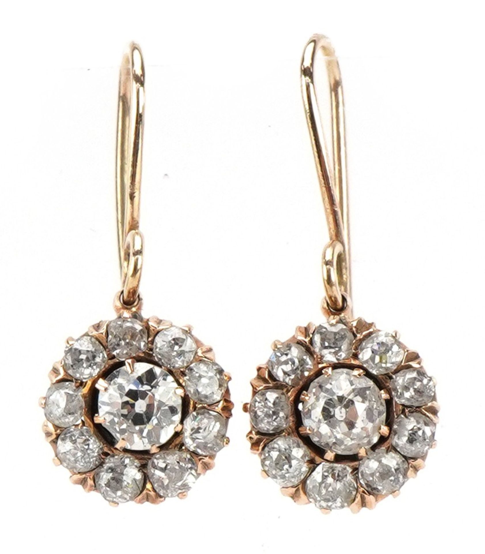 Pair of unmarked gold diamond cluster drop earrings, each centre diamond approximately 0.30 carat,