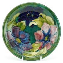 William Moorcroft pottery plate hand painted in the Clematis green pattern, paper label, signature