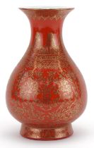Chinese iron red ground porcelain vase gilded with mythical animals amongst flowers, six figure