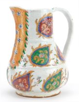 Turkish Ottoman Kutahya porcelain water jug hand painted with stylised flowers within leaves, 19cm