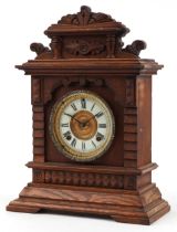 Ansonia, American walnut striking mantle clock with enamelled chapter ring having Roman numerals,