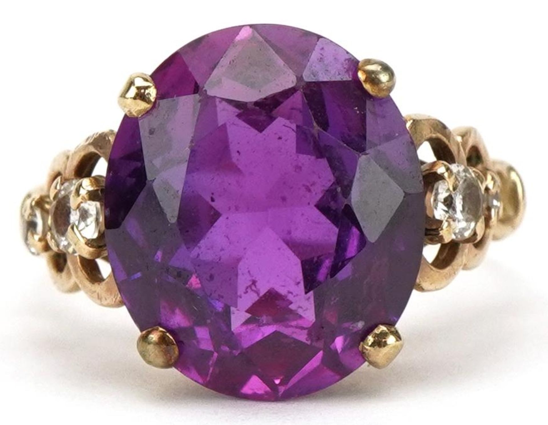 Purple stone solitaire ring, possibly alexandrite, set with clear stone set shoulders, the stone