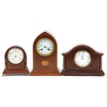 Three Edwardian inlaid mahogany mantle clocks with enamelled dials, the largest 26cm high : For