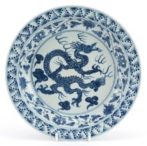Chinese blue and white porcelain shallow bowl hand painted with a dragon amongst clouds within a