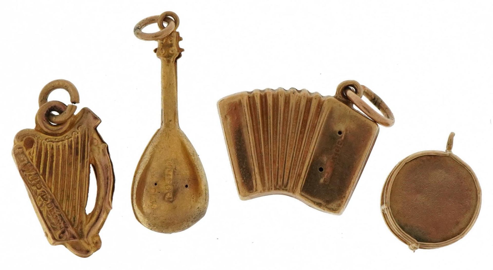 Four 9ct gold musical instrument charms comprising mandolin, accordion, drum and harp, the largest - Image 2 of 6