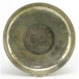 Chinese white metal dragon dish inset with a coin, 9.5cm in diameter : For further information on