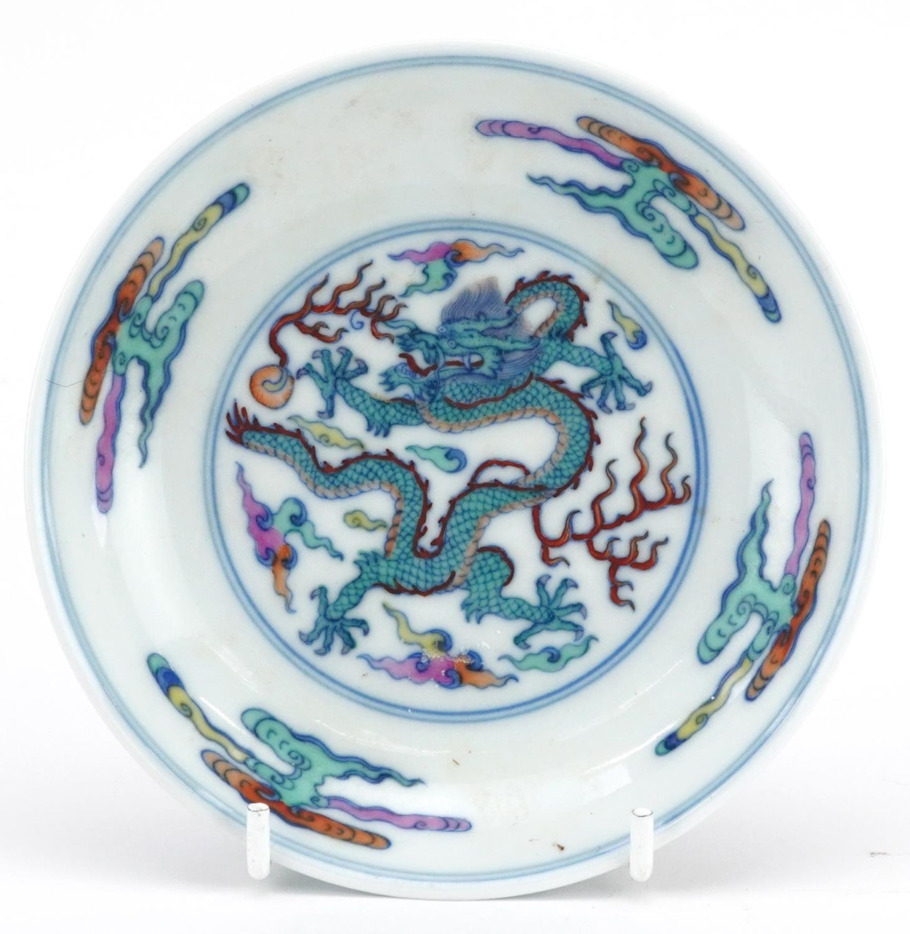 Chinese doucai porcelain dish hand painted with a dragon chasing the flaming pearl amongst clouds,