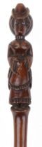 Folk art carved walking stick of a lady with bustle, bouffant hair design and with beaded glass