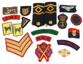 Military and naval cloth badges and shoulder titles including Intelligence Corps and Royal Artillery