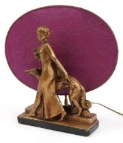 Art Deco gilt plaster figural table lamp with shade in the form of a female with dog, 42cm wide :