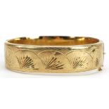 9ct gold hinged bangle with engraved floral decoration, 6.5cm wide, 21.8g : For further