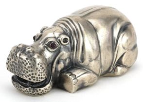 Silver recumbent hippopotamus with ruby eyes, impressed Russian marks to the base, 7.5cm in