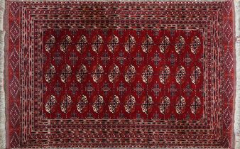 Rectangular Persian red ground rug having an allover repeat floral design, 190cm x 120cm : For