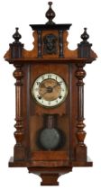 19th century walnut and mahogany Vienna wall clock with with columns having enamelled chapter ring