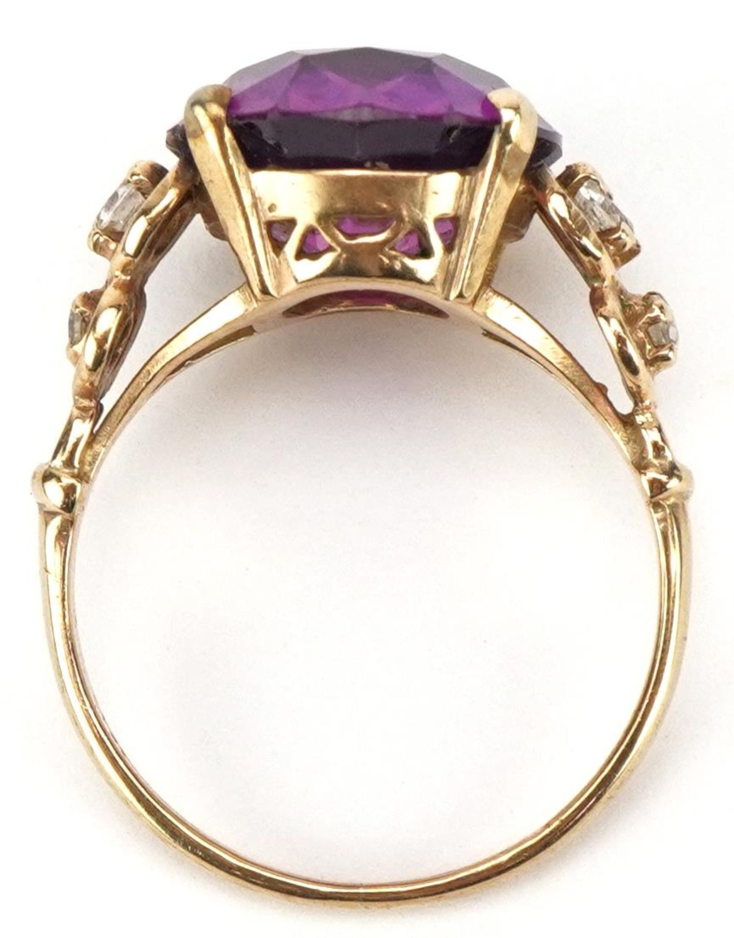 Purple stone solitaire ring, possibly alexandrite, set with clear stone set shoulders, the stone - Image 3 of 4