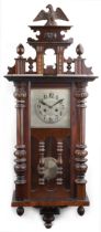 Mahogany Vienna striking wall clock having a silvered dial with Arabic numerals, 112cm high : For