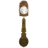 19th century French wall clock with embossed brass face and pendulum, the circular enamelled dial
