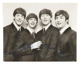 Black and white photograph of The Beatles with ink signatures, probably by assistants, 25.5cm x 20cm