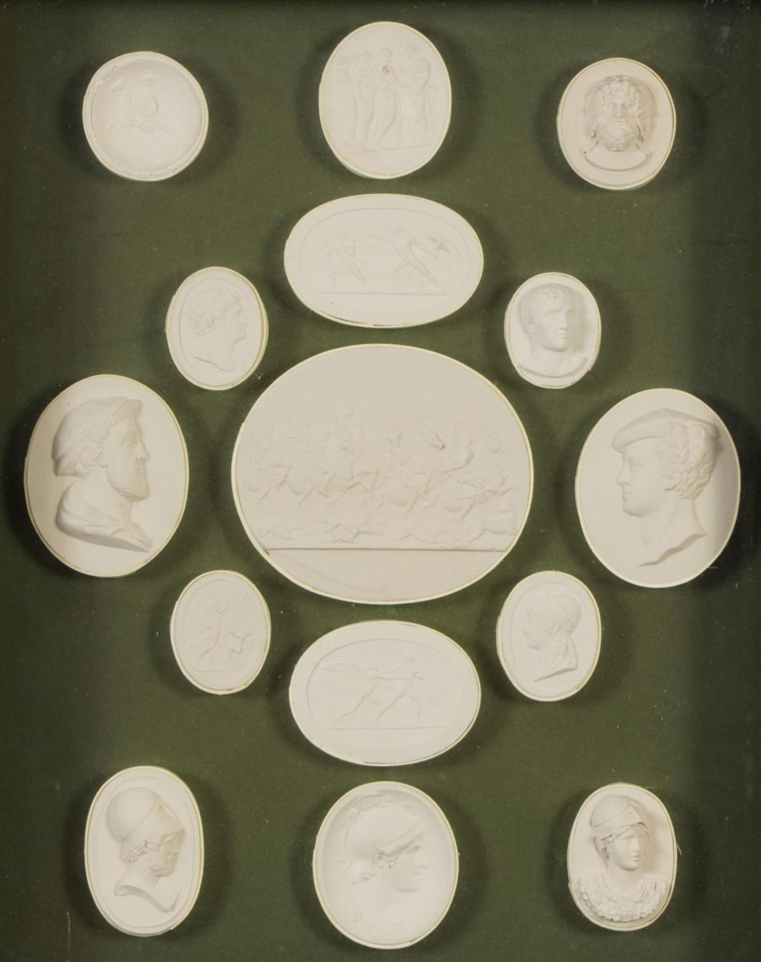 Fifteen Grand Tour plaster cameos arranged in a framed, glazed display including one entitled