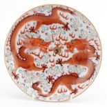 Chinese porcelain shallow dish hand painted in the famille rose palette in iron red with two dragons