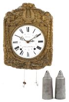 19th century French wall clock having brass face embossed with a lyre and flowers, the circular