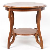 Mahogany centre table with serpentine outline and under tier, 62cm high x 67cm in diameter : For